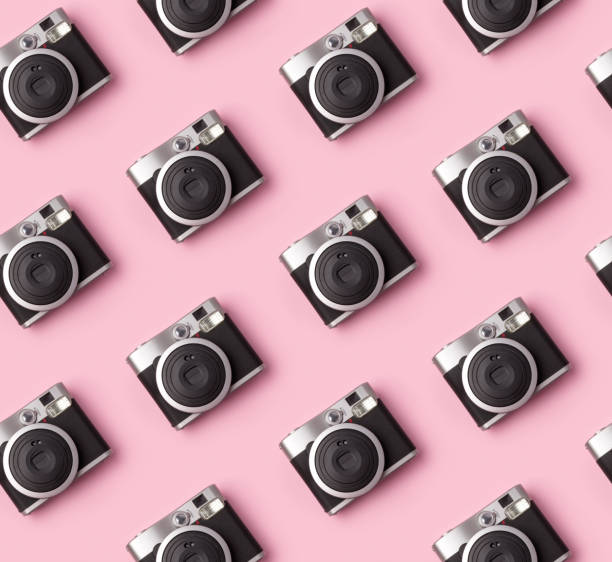 istock Seamless pattern with vintage instant camera at pastel pink background. 1166466385