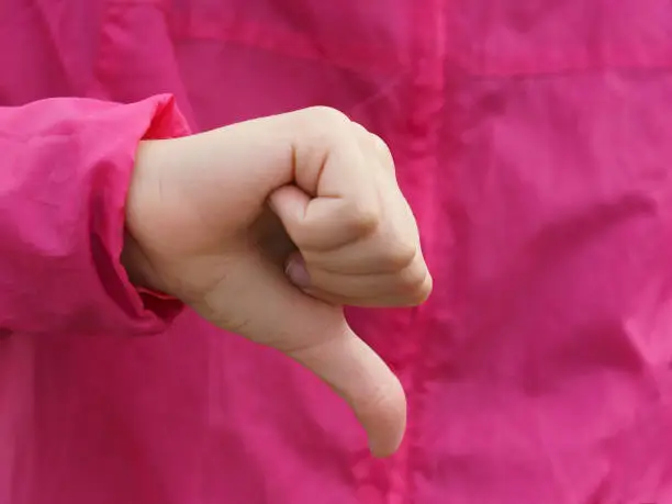 Photo of Sign language. Thumb down.