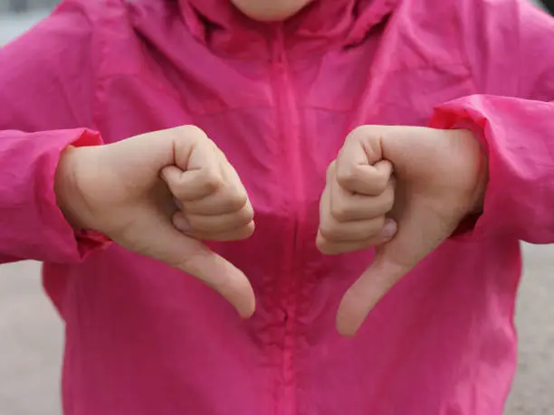 Photo of Sign language. Thumb down.