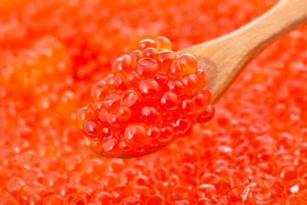 istock little spoon with red caviar close-up and red roe 1166468694