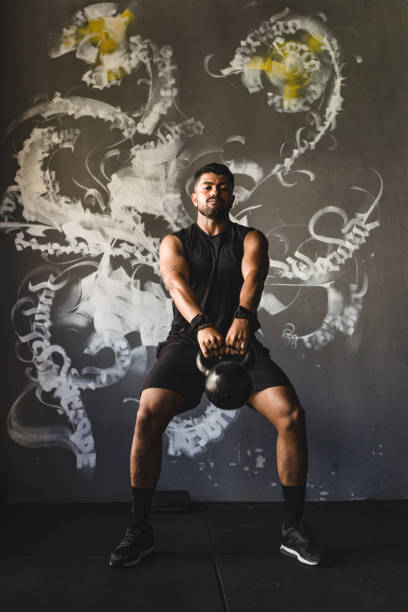 istock Athlete lifting weight at gym 1166468799