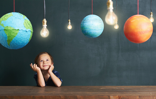 Child learning about planets and space on classroom