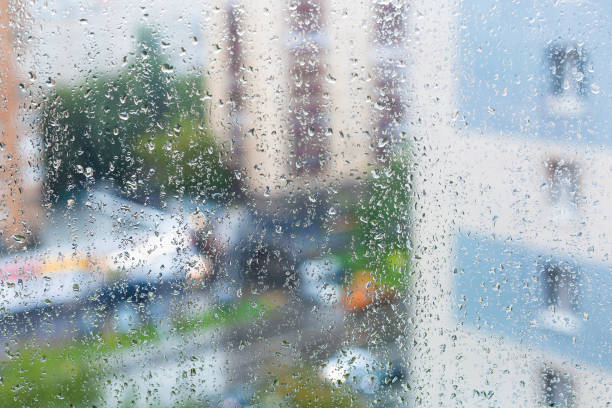 istock raindrops on window glass and blurred city street 1166473254