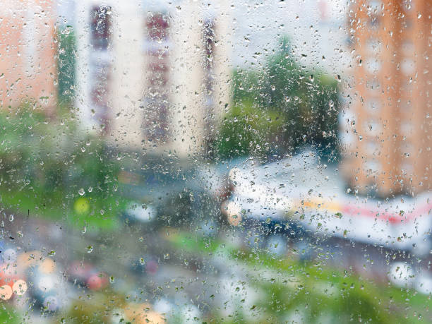 istock raindrops on home window glass and blurred street 1166473262