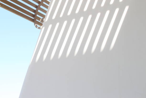 Modern house exterior with white walls and beamed ceilings above the balcony or open corridor. A minimalist aesthetic architectural concept.