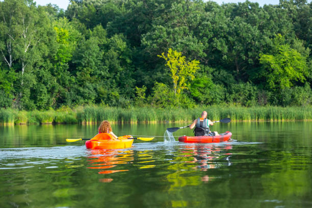 istock Father Towing Daughter in Kayak on Lake 1166477835