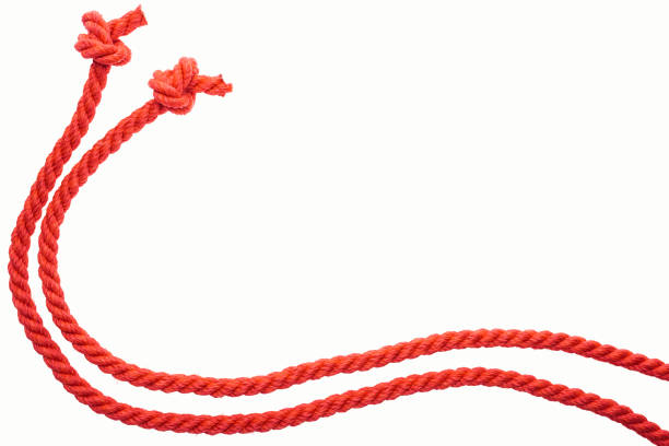 istock red long curled ropes with knots isolated on white 1166478335
