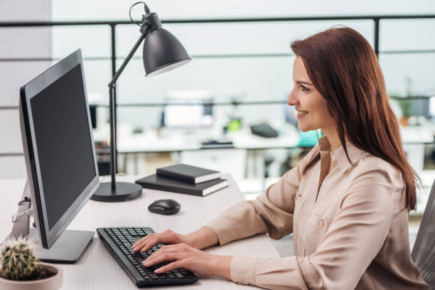 istock smiling young woman typing on computer keyboard at workplace in modern office 1166478619