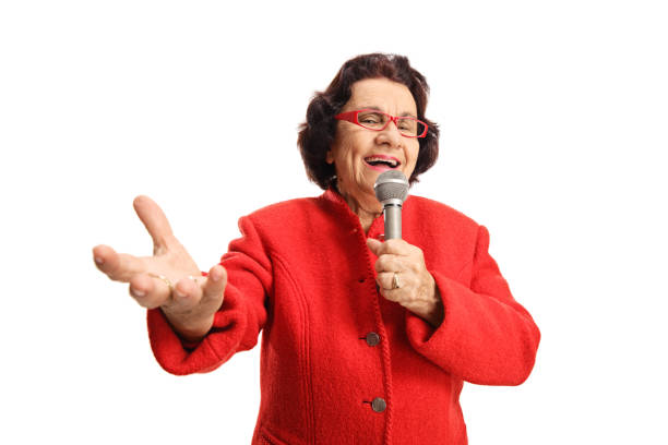 istock Cheerful elderly lady singing on a microphone and enjoying 1166478629