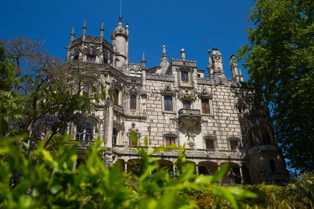 SINTRA, PORTUGAL - APRIL 21, 2019: Picturesque landscape with neo-gothic mystical palace of Baroness Regaleira in Quinta da Regaleira near historic center of Sintra