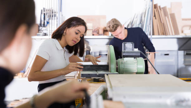 istock Female architect polishing elements of architectural model 1166480590
