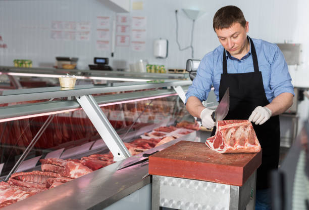 istock Butcher cutting raw steak on ribs 1166482193