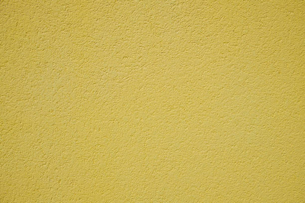 istock Yellow rough surface of the plastered wall 1166483744