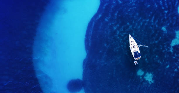 istock Yacht on the water surface from top view. Turquoise water background from top view. Summer seascape from air. Croatia. Travel - image 1166484061