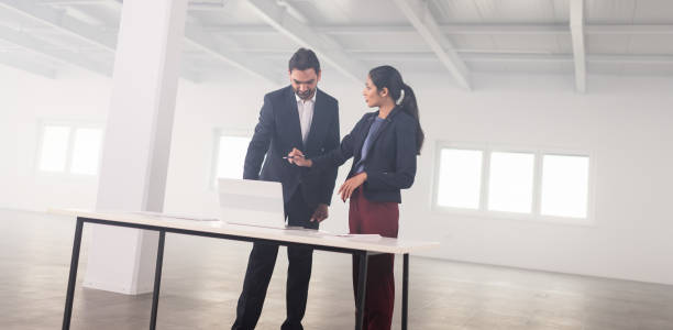 istock Businesspeople Meeting To Look At Plans In Empty Office 1166484262