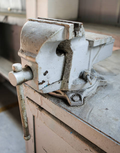 istock Shallow depth of field image with a rusty and dirty heavy iron vice on a workbench inside a workshop with no people around 1166485124