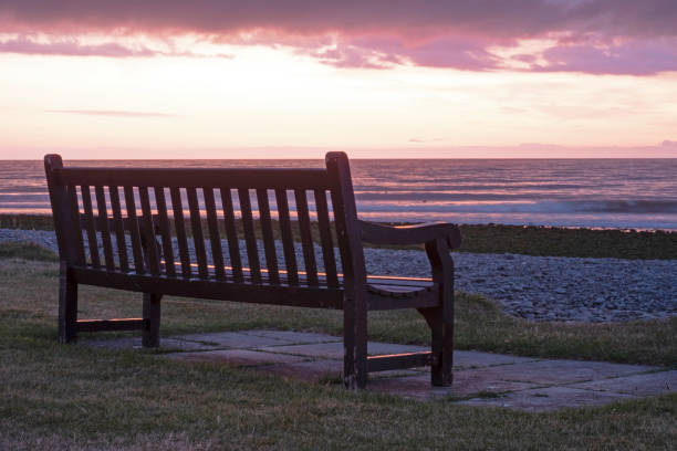 istock park bench at dusk on a wales summer coastline 1166485402