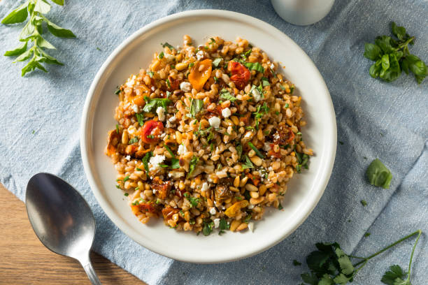 Homemade Healthy Farro Tomato Salad Homemade Healthy Farro Tomato Salad with Herbs tomato rice stock pictures, royalty-free photos & images