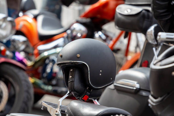 istock black retro helmet on a leather motorcycle seat. On a blurred background other motorbikes out of focus 1166486407