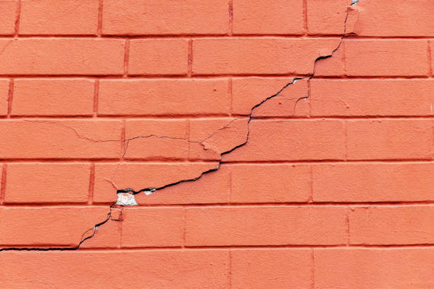 istock crack in the red brick wall. real collapsing wall of a building 1166486628