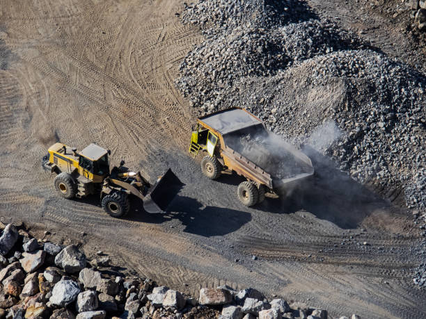 istock Excavator loading dumper truck on mining site stock photo 1166488626