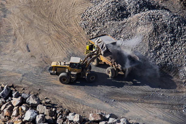istock Excavator loading dumper truck on mining site stock photo 1166488788