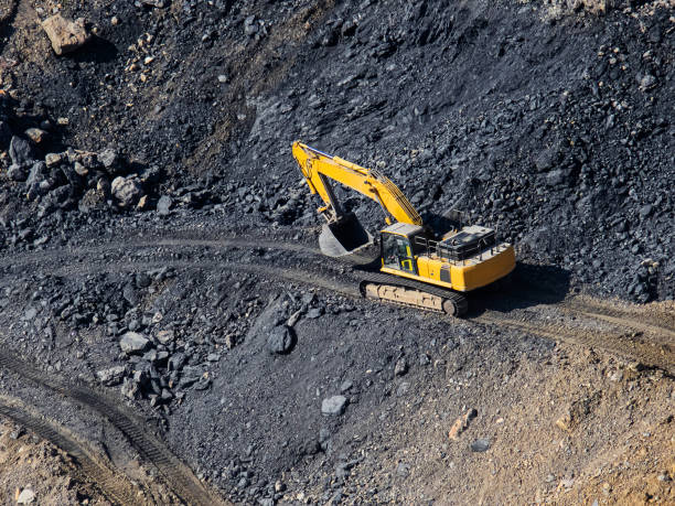 istock Excavator loading dumper truck on mining site stock photo 1166488877