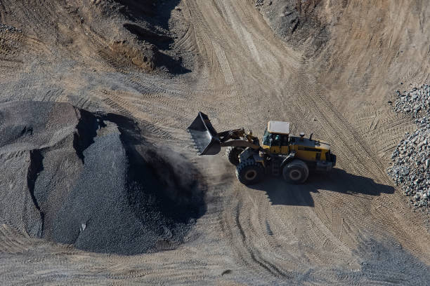 istock Excavator loading dumper truck on mining site stock photo 1166488919