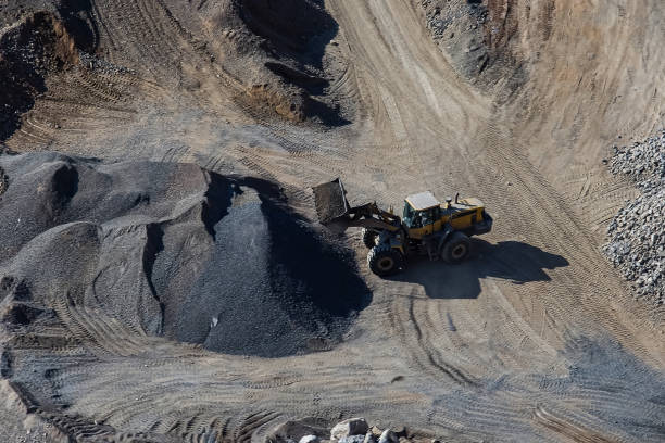 istock Excavator loading dumper truck on mining site stock photo 1166488958