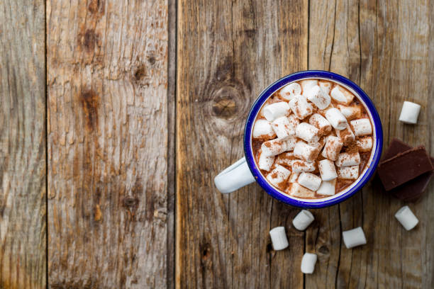 istock hot chocolate in an iron mug with marshmallow on old wooden background 1166489687