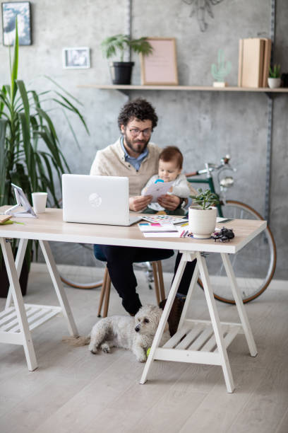 istock Working dad holding his baby son 1166489797