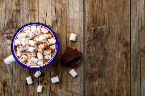 istock hot chocolate in an iron mug with marshmallow on old wooden background 1166490043
