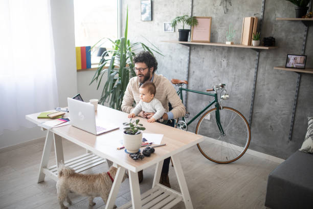 istock Father and son video chatting on laptop 1166490619