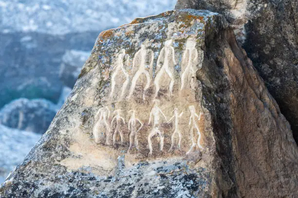 Photo of Ancient petroglyph depicting human figures in Gobustan, Azerbaijan.
