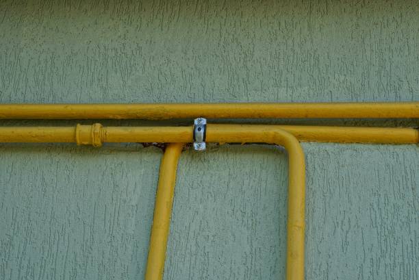 istock yellow metal gas pipes on a gray wall 1166496839