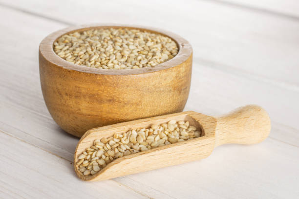 istock Unpeeled sesame seeds on grey wood 1166497147