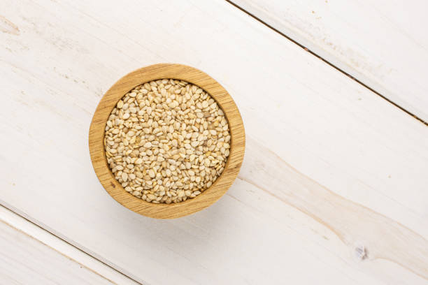 istock Unpeeled sesame seeds on grey wood 1166497148