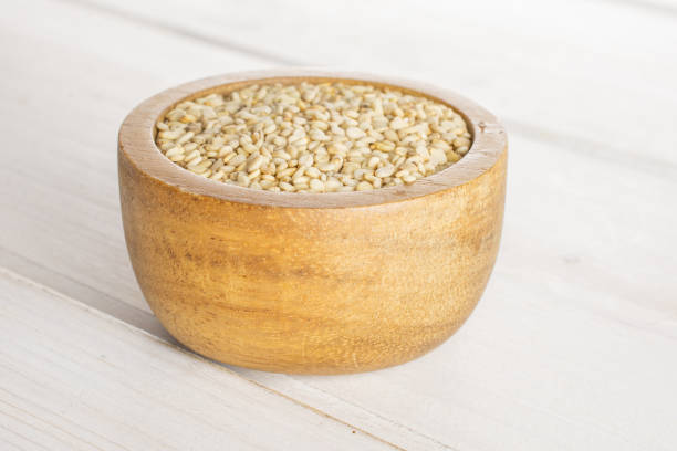 istock Unpeeled sesame seeds on grey wood 1166497149