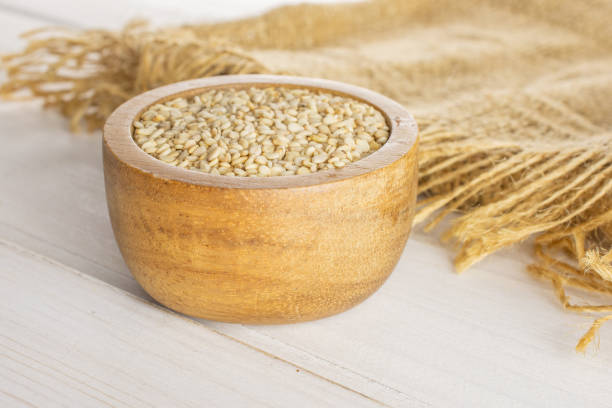 istock Unpeeled sesame seeds on grey wood 1166497152