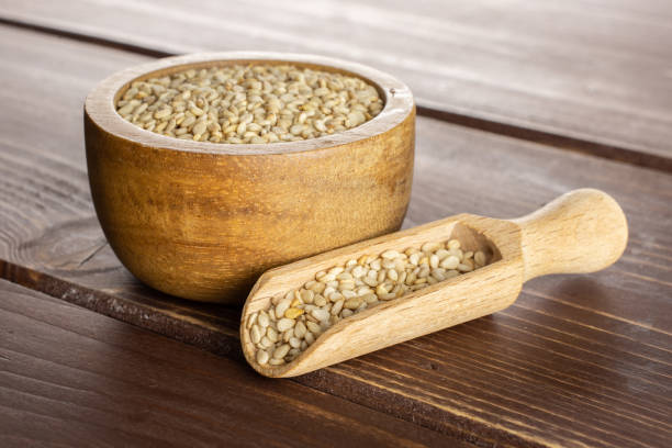 istock Unpeeled sesame seeds on brown wood 1166497156