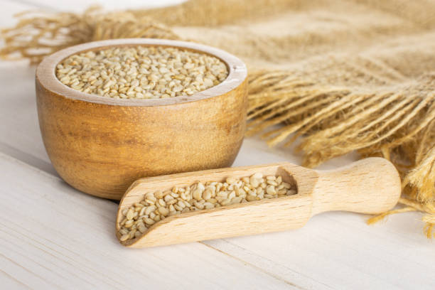 istock Unpeeled sesame seeds on grey wood 1166497196