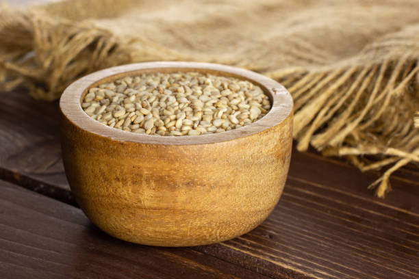istock Unpeeled sesame seeds on brown wood 1166497209