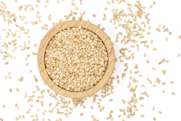 istock Unpeeled sesame seeds isolated on white 1166497268