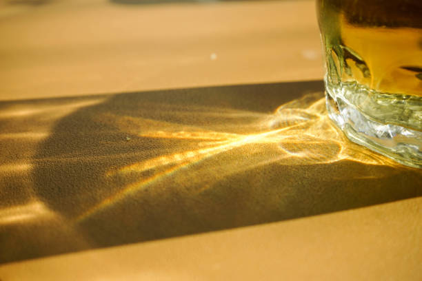 Solar patterns through a glass of water