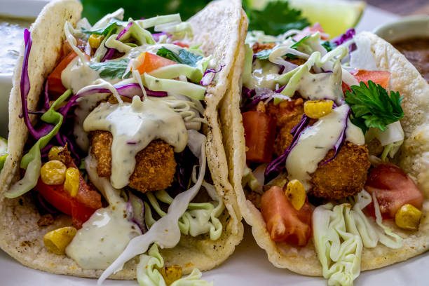 istock Oven-fried fish tacos with cabbage tomatoes, roasted corn and avocado-cilandro sauce 1166499548