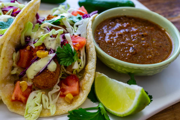 istock Oven-fried fish tacos with cabbage tomatoes, roasted corn and avocado-cilandro sauce 1166499560