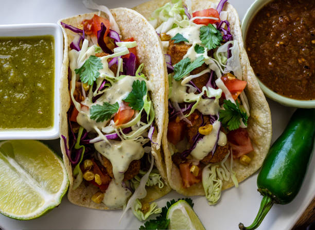 istock Oven-fried fish tacos with cabbage tomatoes, roasted corn and avocado-cilandro sauce 1166499573