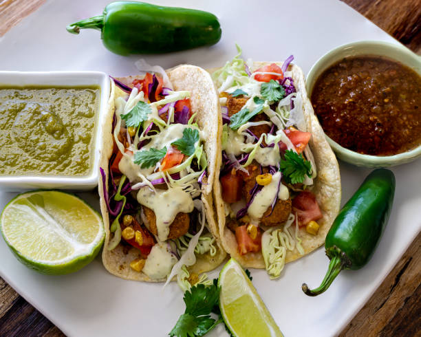 istock Oven-fried fish tacos with cabbage tomatoes, roasted corn and avocado-cilandro sauce 1166499580