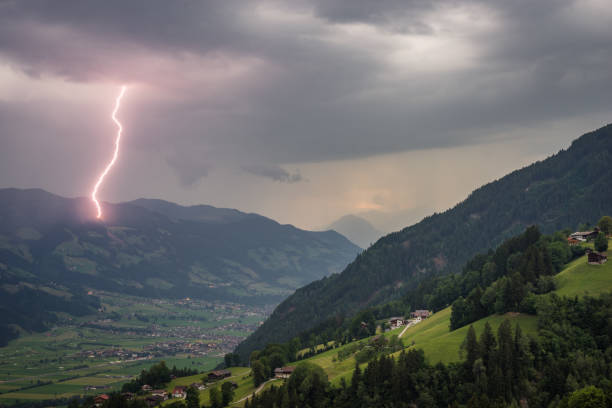 daytime lightning bolt strikes in the mountains of tirol, austria - summer landscape flash imagens e fotografias de stock