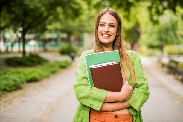 istock Cheerful young woman going to college. 1166505928